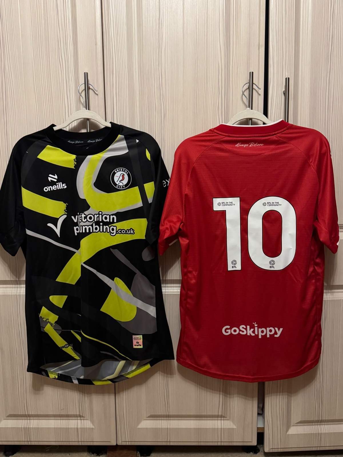 Black and yellow Bristol City goalkeeper shirt beside the red number 10 shirt